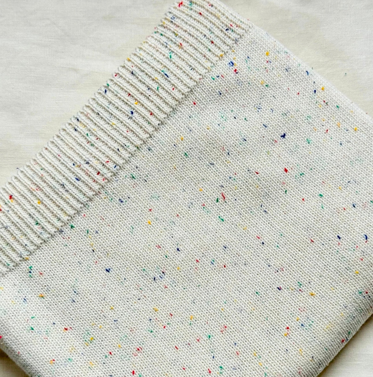 Organic cotton rainbow fleck knitted baby blanket